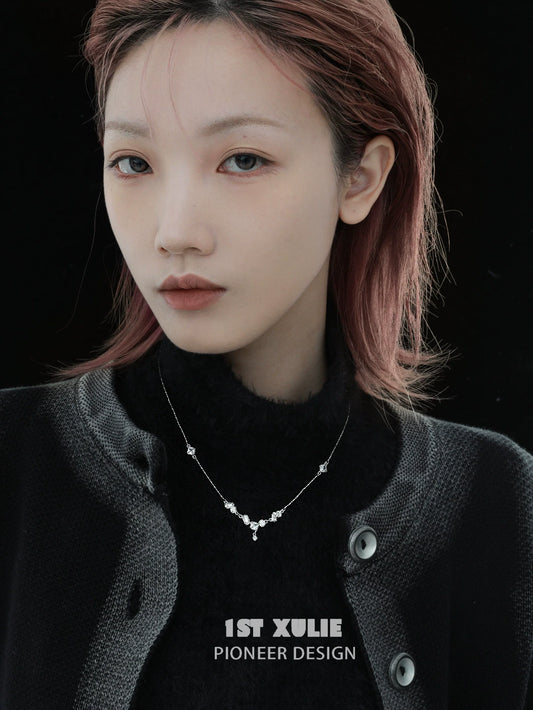 Model wearing an edgy zircon necklace from 1STXULIE with a stylish black outfit