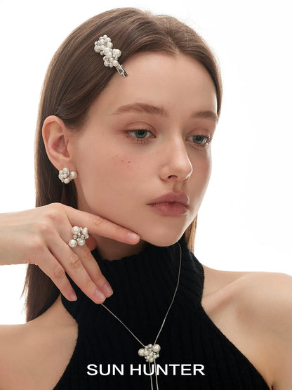 Elegant pearl statement ring paired with matching jewelry for a chic and stylish look