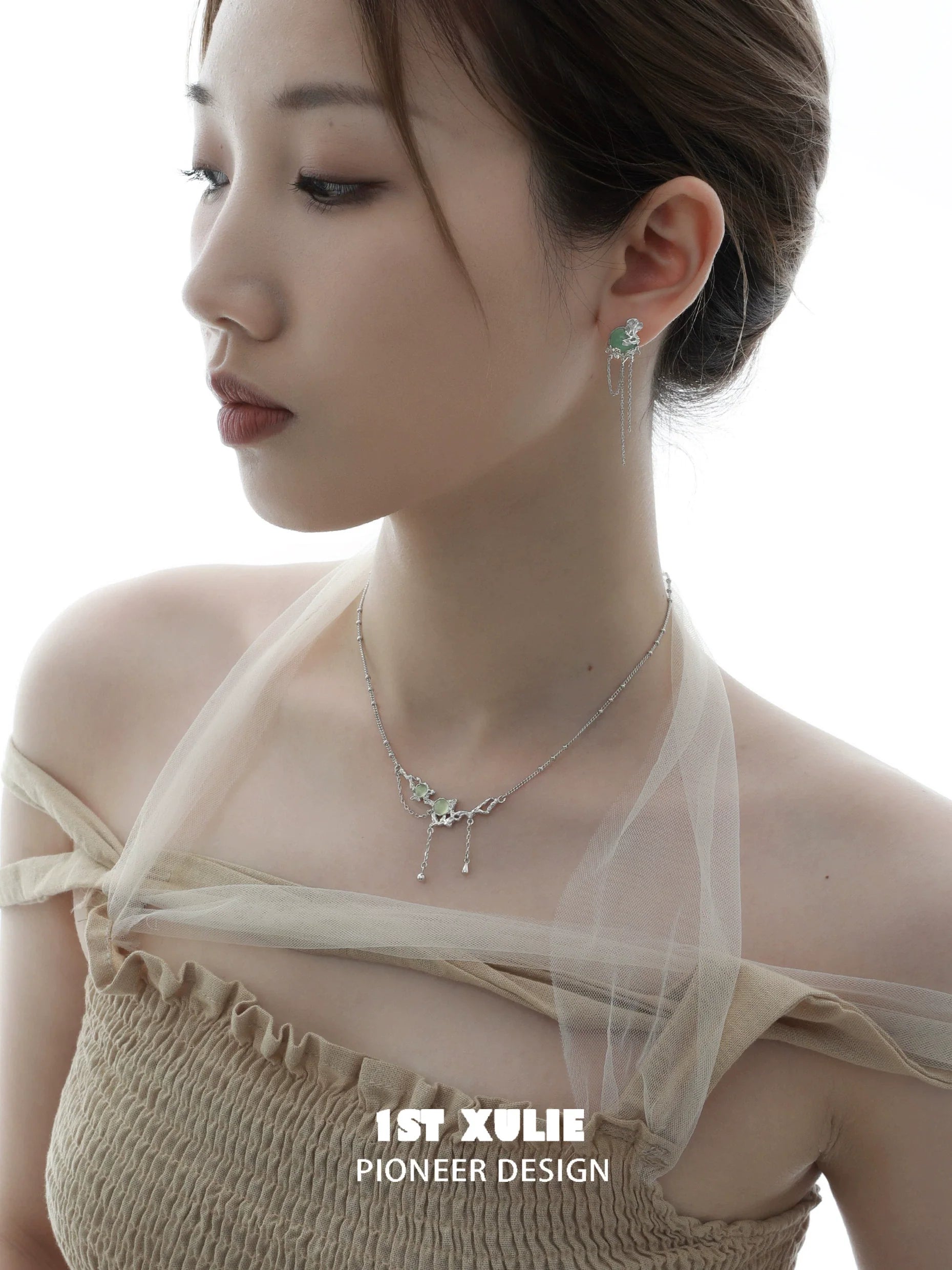 Elegant queen fringe earrings in silver, styled with a matching necklace for a chic look