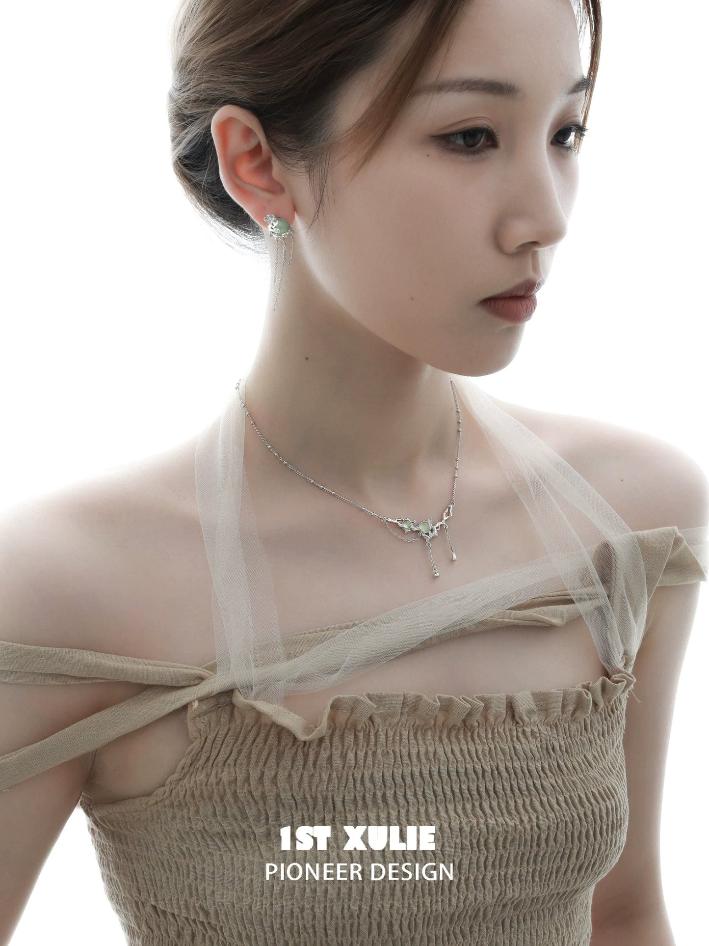 Elegant queen fringe earrings showcased on a model with a delicate hairstyle and soft lighting