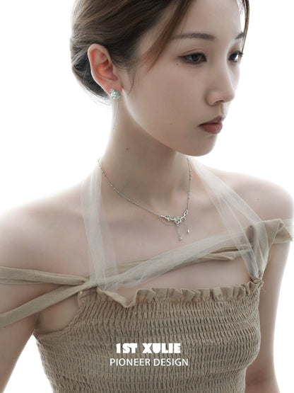 Elegant queen fringe earrings showcased on a model with a delicate hairstyle and soft lighting