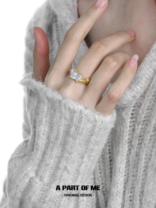 Elegant feather rose engraved ring in gold worn on a hand with a cozy sweater