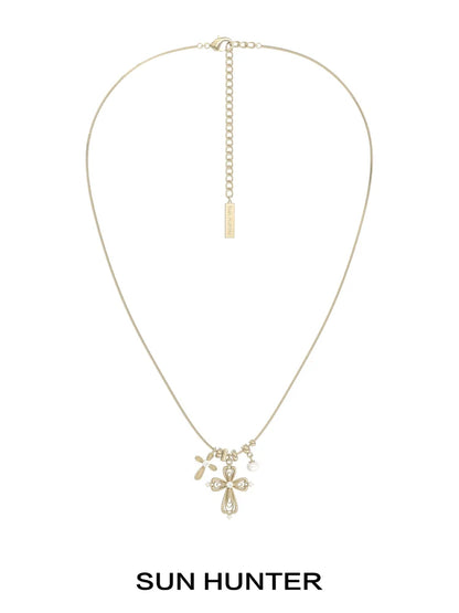 Sun Hunter faith charm necklace featuring a delicate cross and charm design in gold