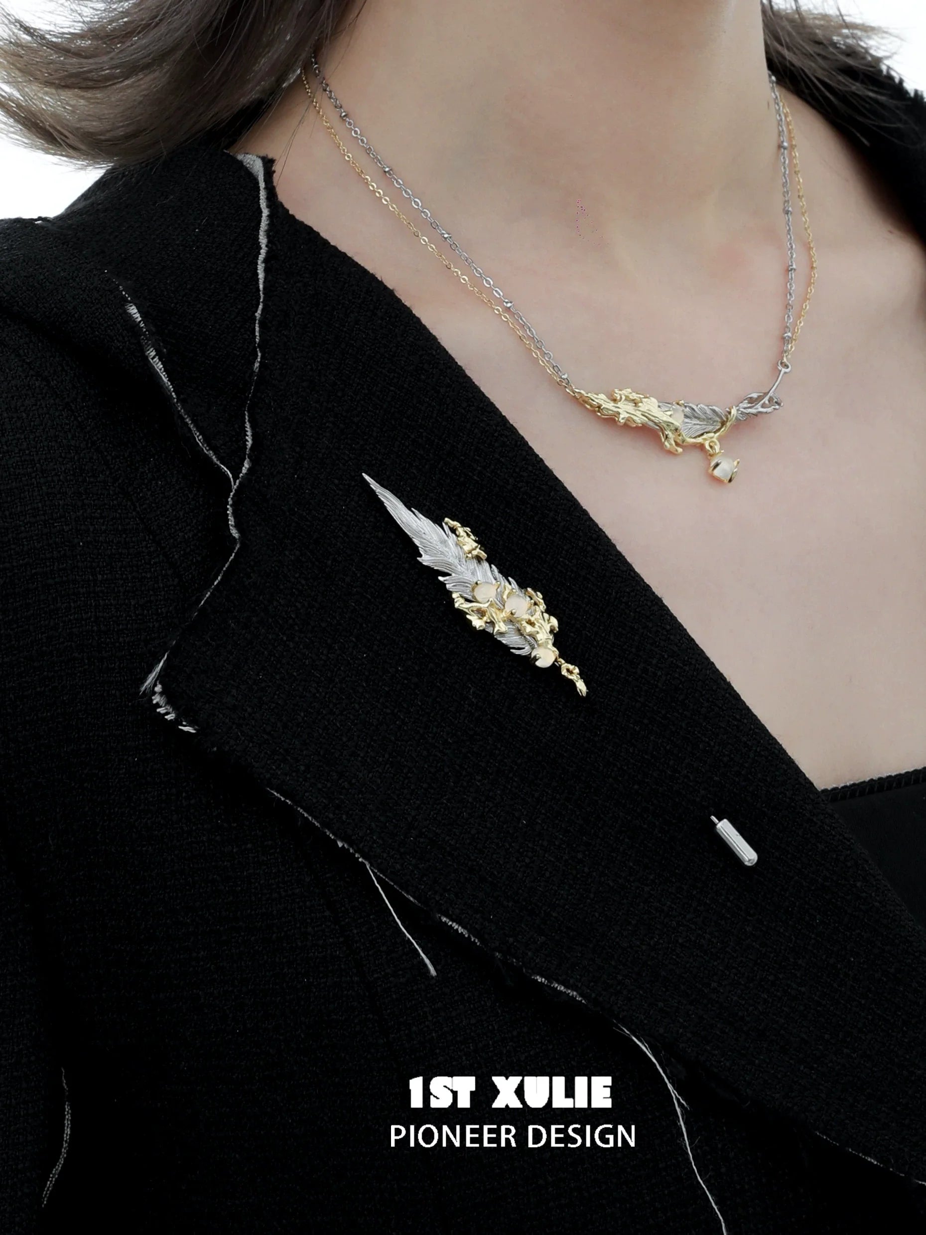 Elegant feather couple brooch displayed on a black blazer, adding a stylish touch to any outfit