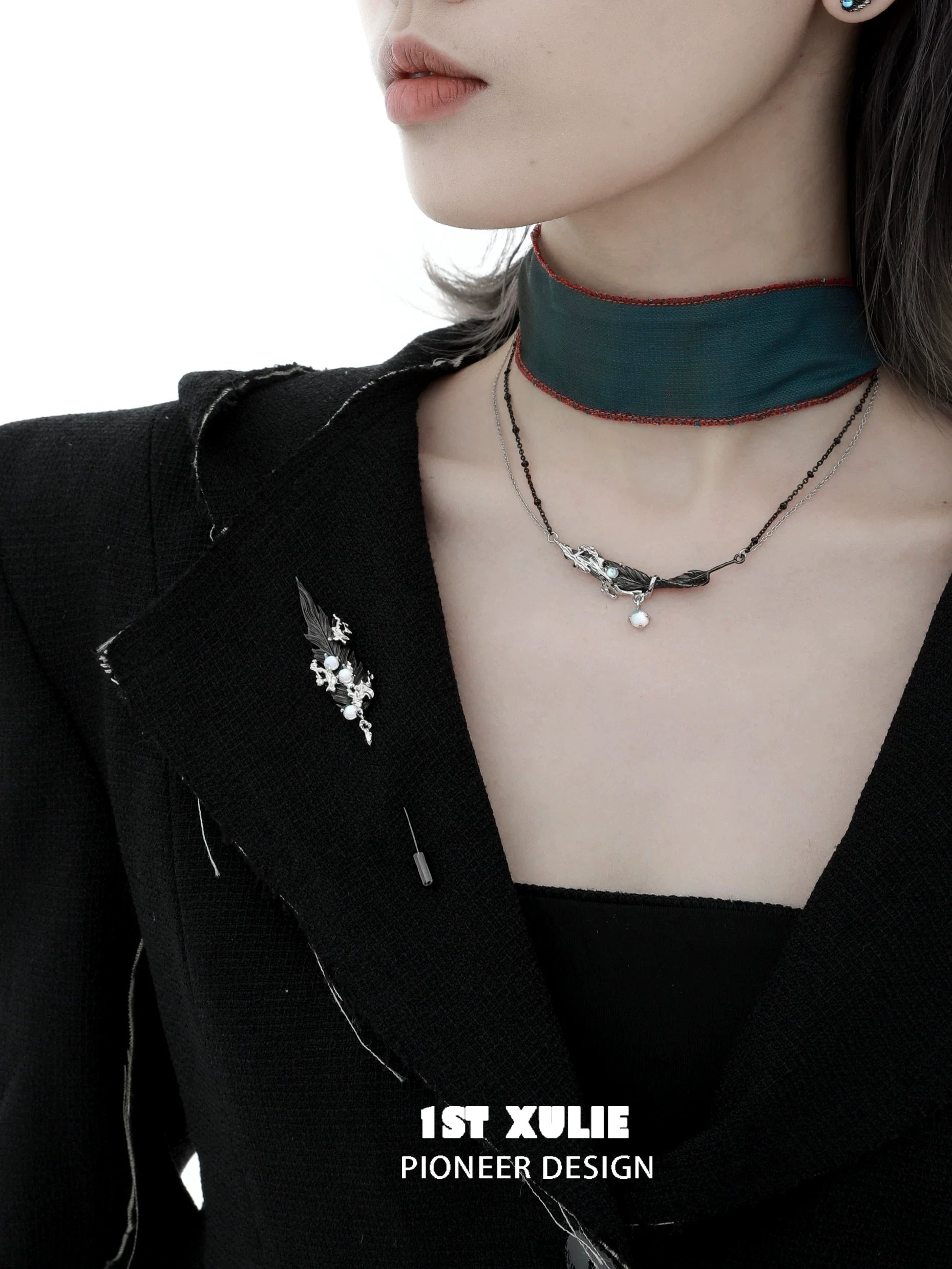 Elegant feather couple brooch displayed on a black jacket with chic accessories, perfect for stylish outfits