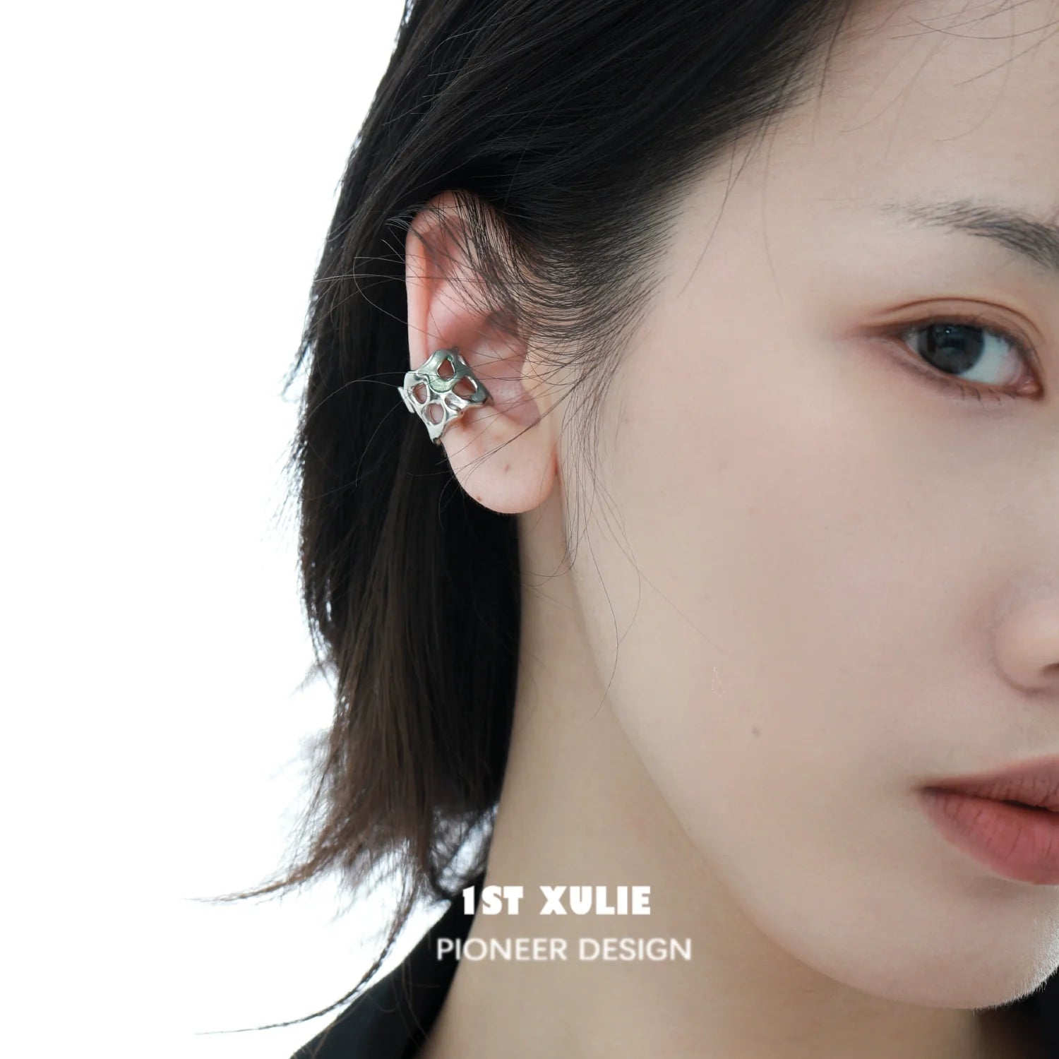Stylish 1STXULIE frozen edge ear cuff displayed on a model's ear for a modern accessory look