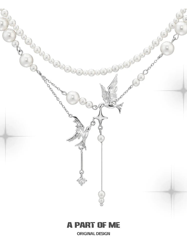 A PART OF ME flying bird pearl necklace featuring elegant design with silver accents and pearl strands
