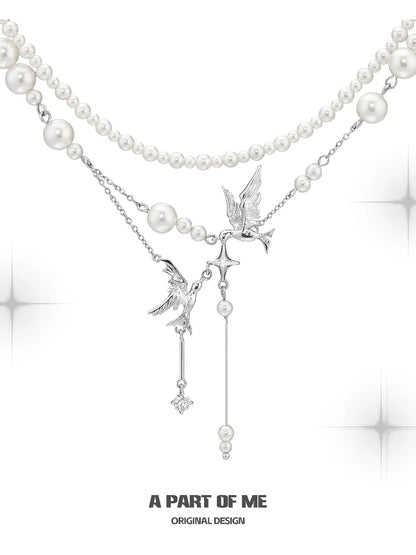 A PART OF ME flying bird pearl necklace featuring elegant design with silver accents and pearl strands