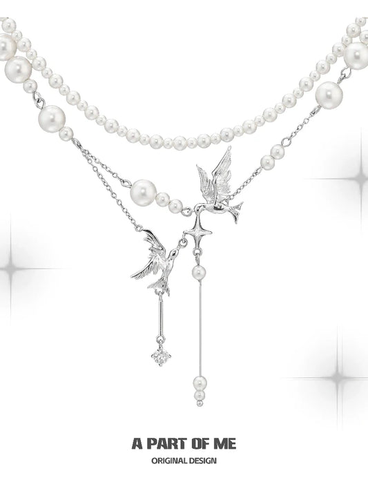 A PART OF ME flying bird pearl necklace featuring elegant design with silver accents and pearl strands