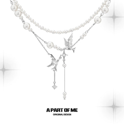 A PART OF ME flying bird pearl necklace featuring elegant bird charms and lustrous pearls