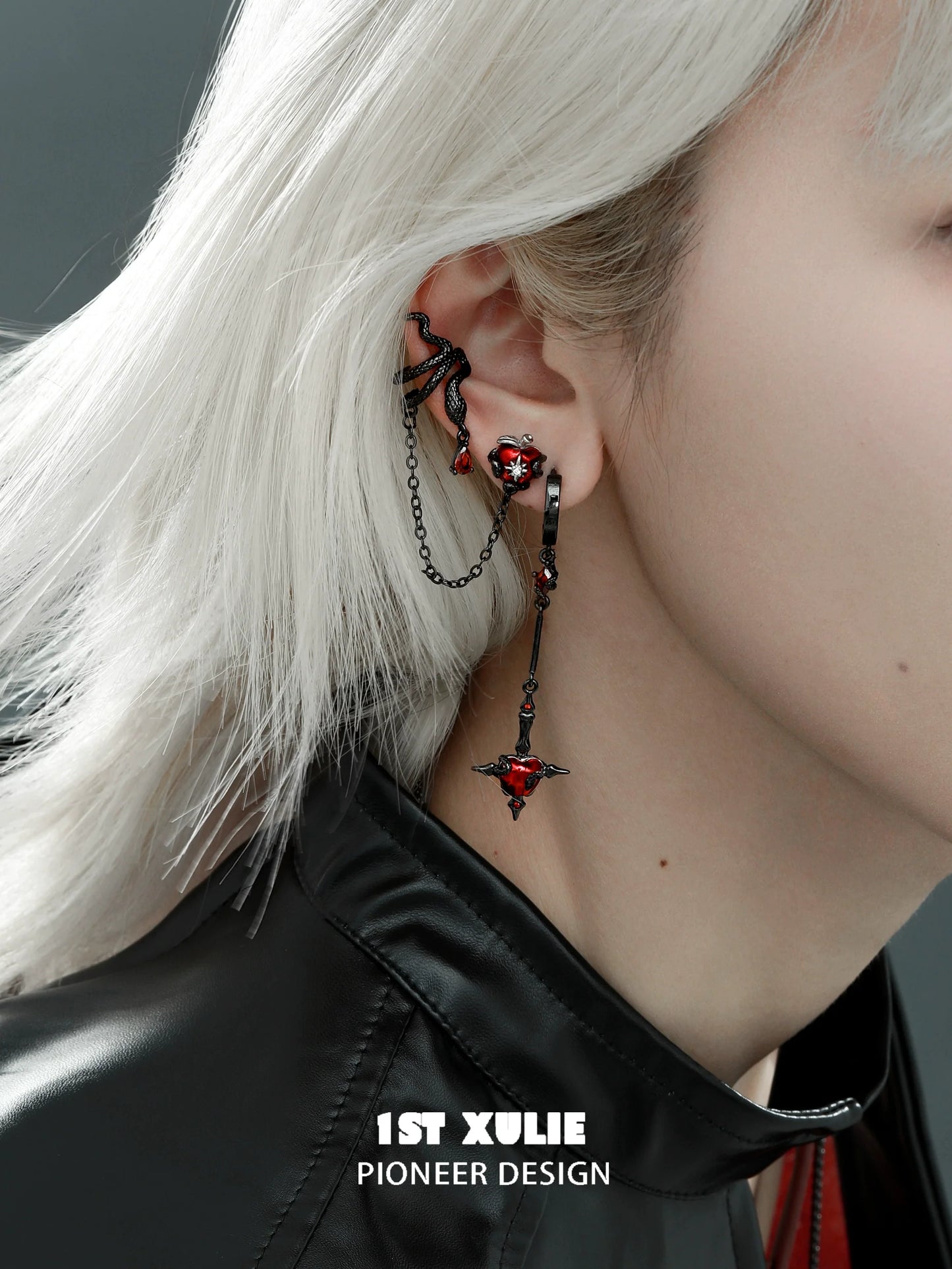 Forbidden apple serpent earrings with intricate design and red accents showcased on a model's ear