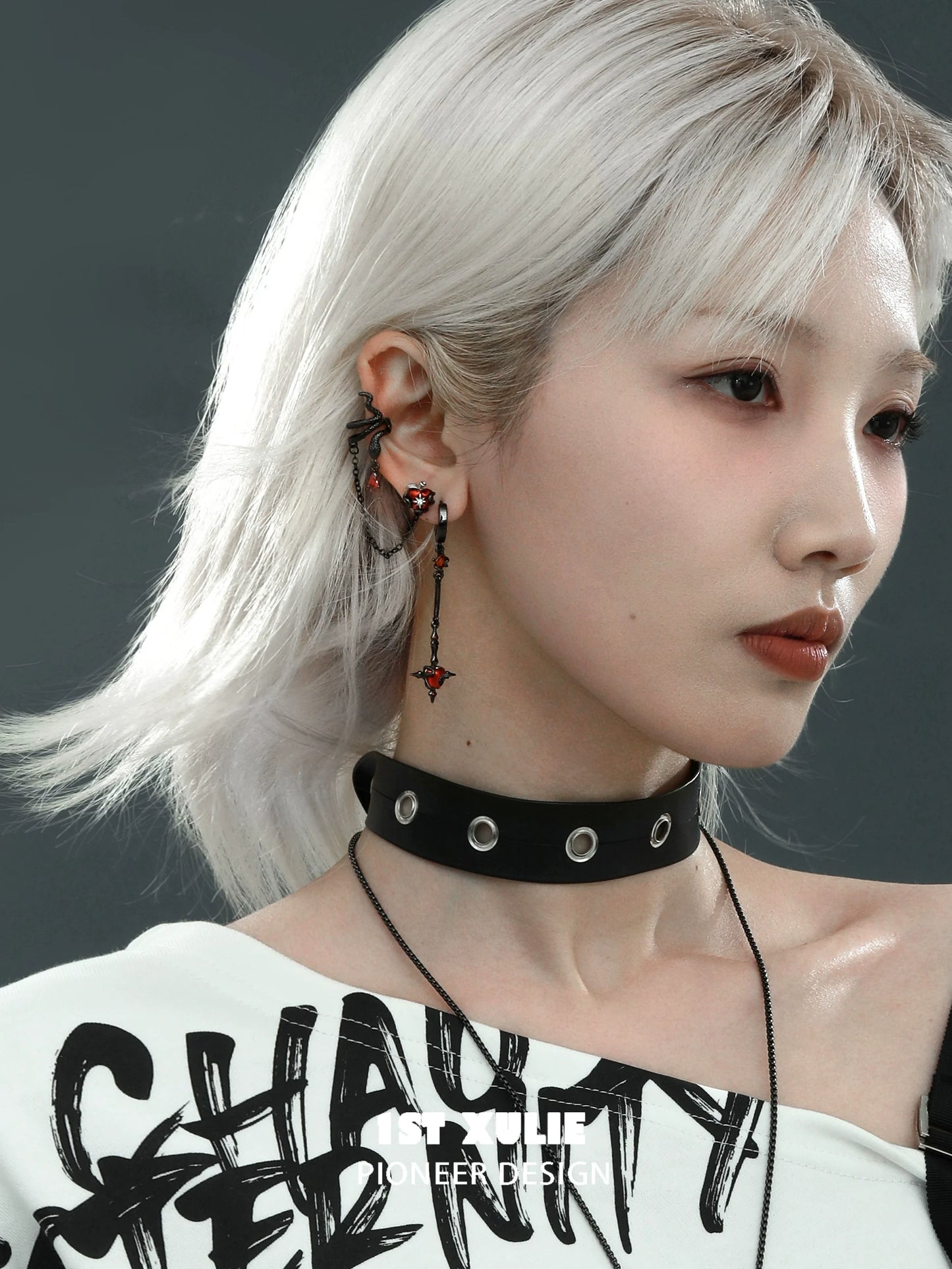 Model wearing forbidden apple serpent earrings with unique design and edgy style