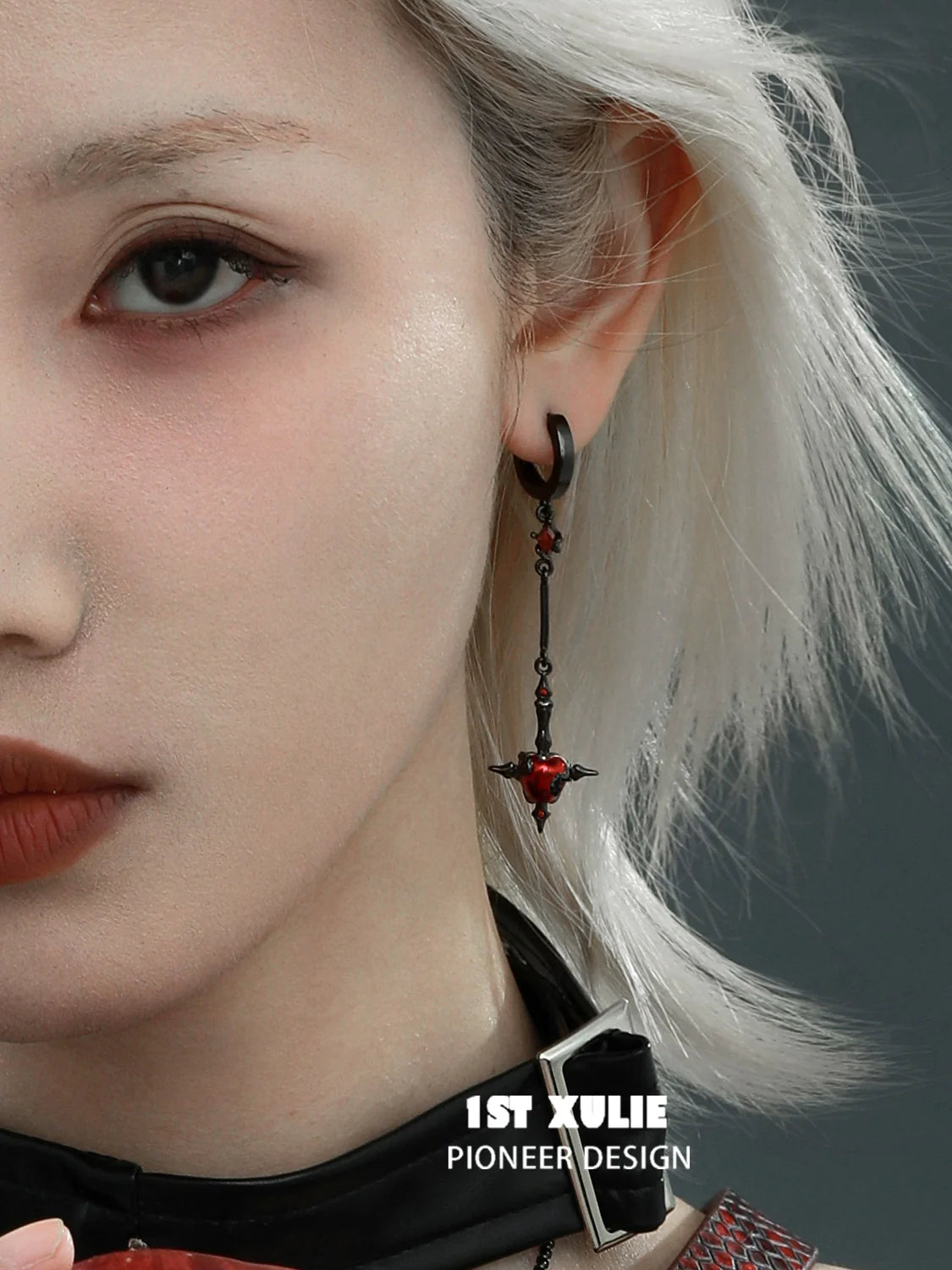 Forbidden apple serpent earrings with intricate design and red accents for a bold fashion statement