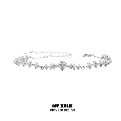 Elegant four-point star silver bracelet featuring intricate design and sparkling accents