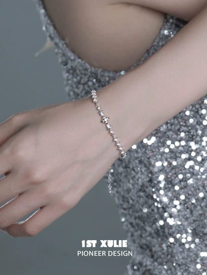 Elegant four-point star silver bracelet showcased on a hand, perfect for stylish occasions