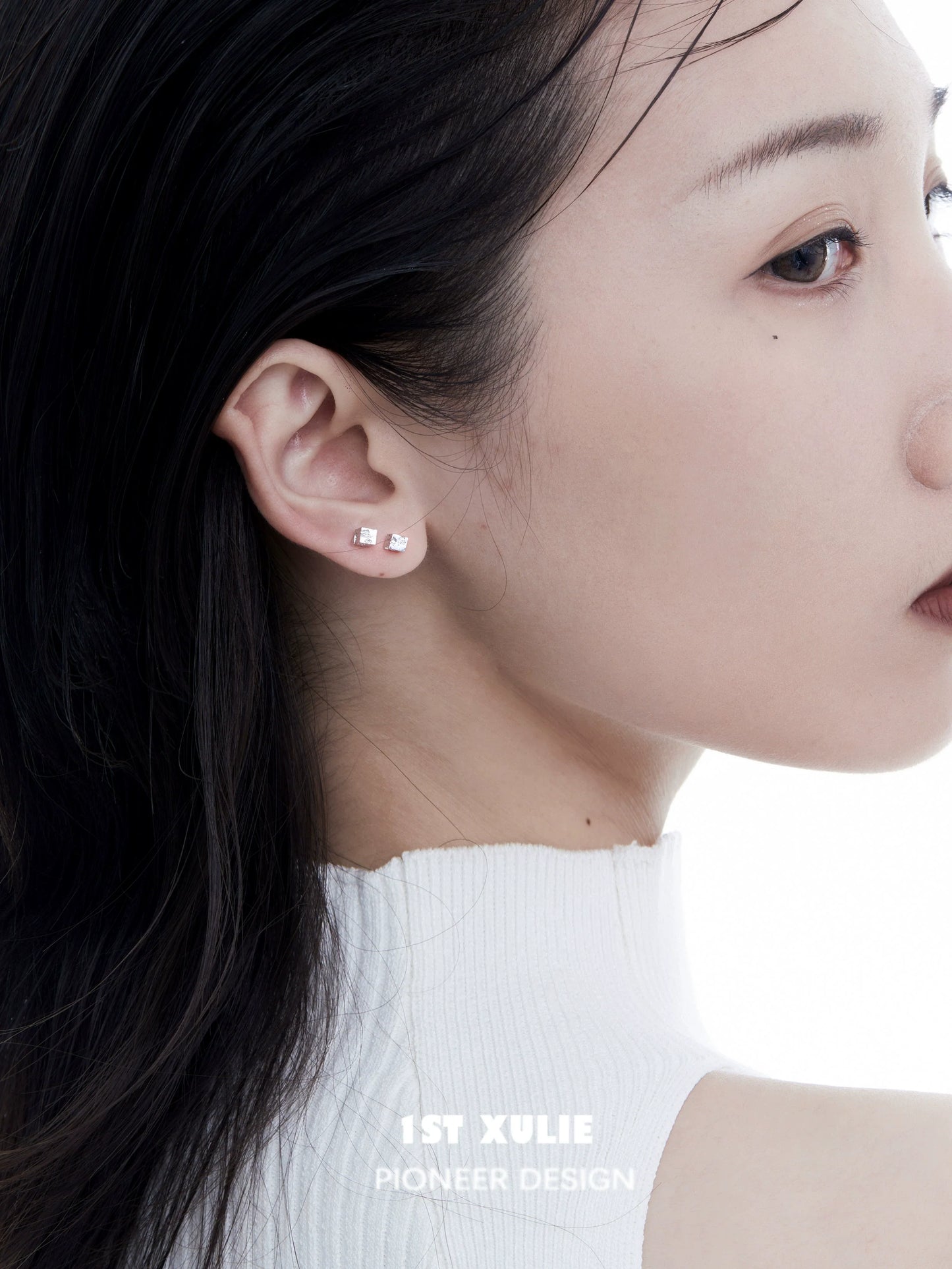 Elegant frosted cube earrings showcased on a model with a sleek hairstyle and minimal makeup