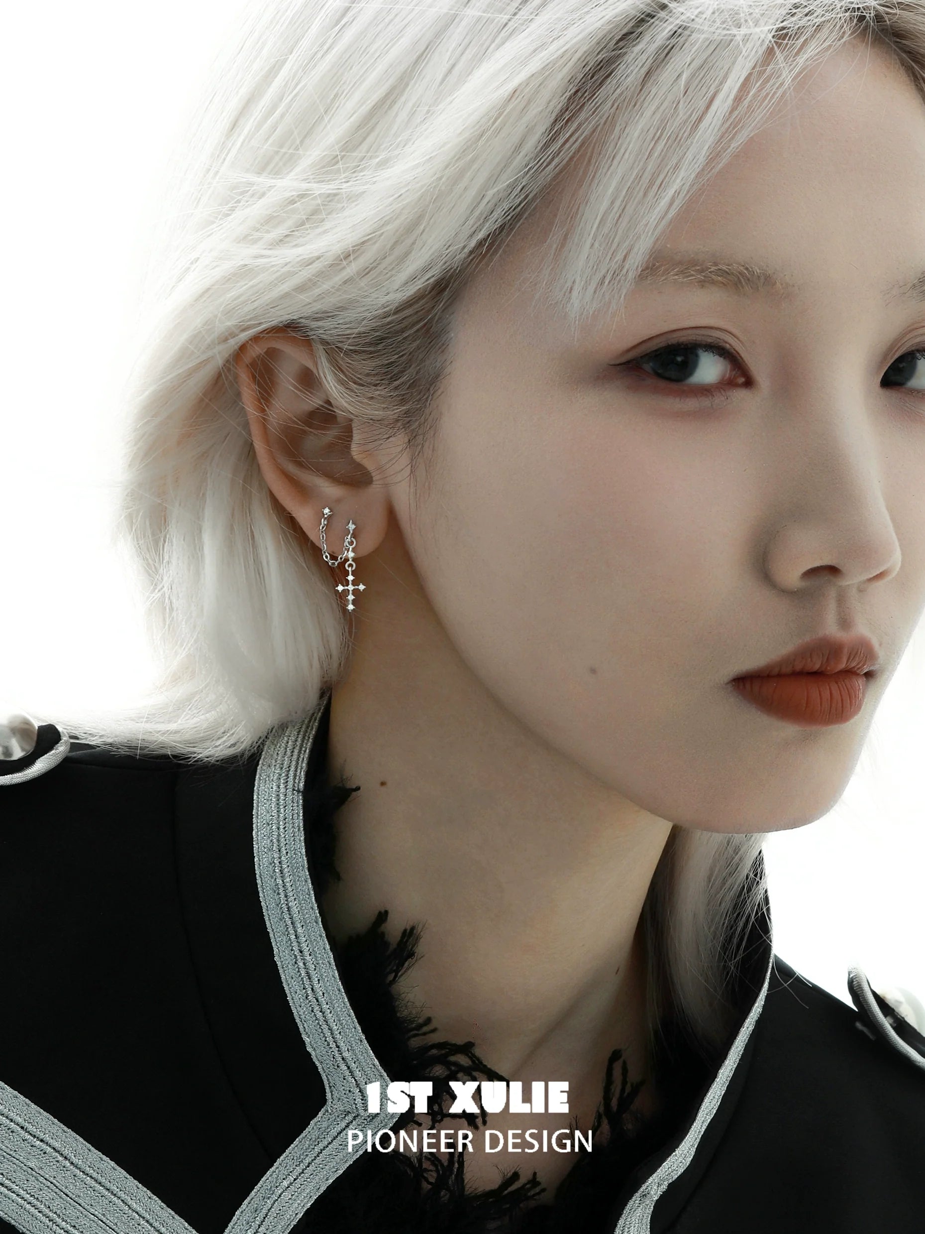 Elegant model wearing 1STXULIE futuristic cross chain earrings with a unique design