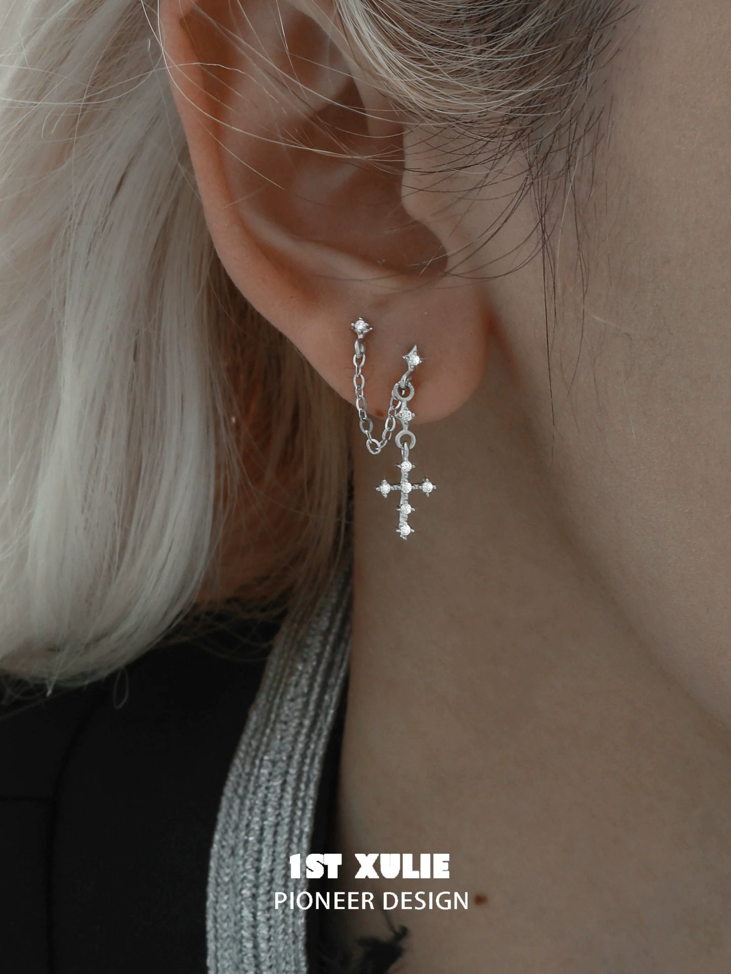 Stylish futuristic cross chain earrings featuring silver chains and sparkling embellishments