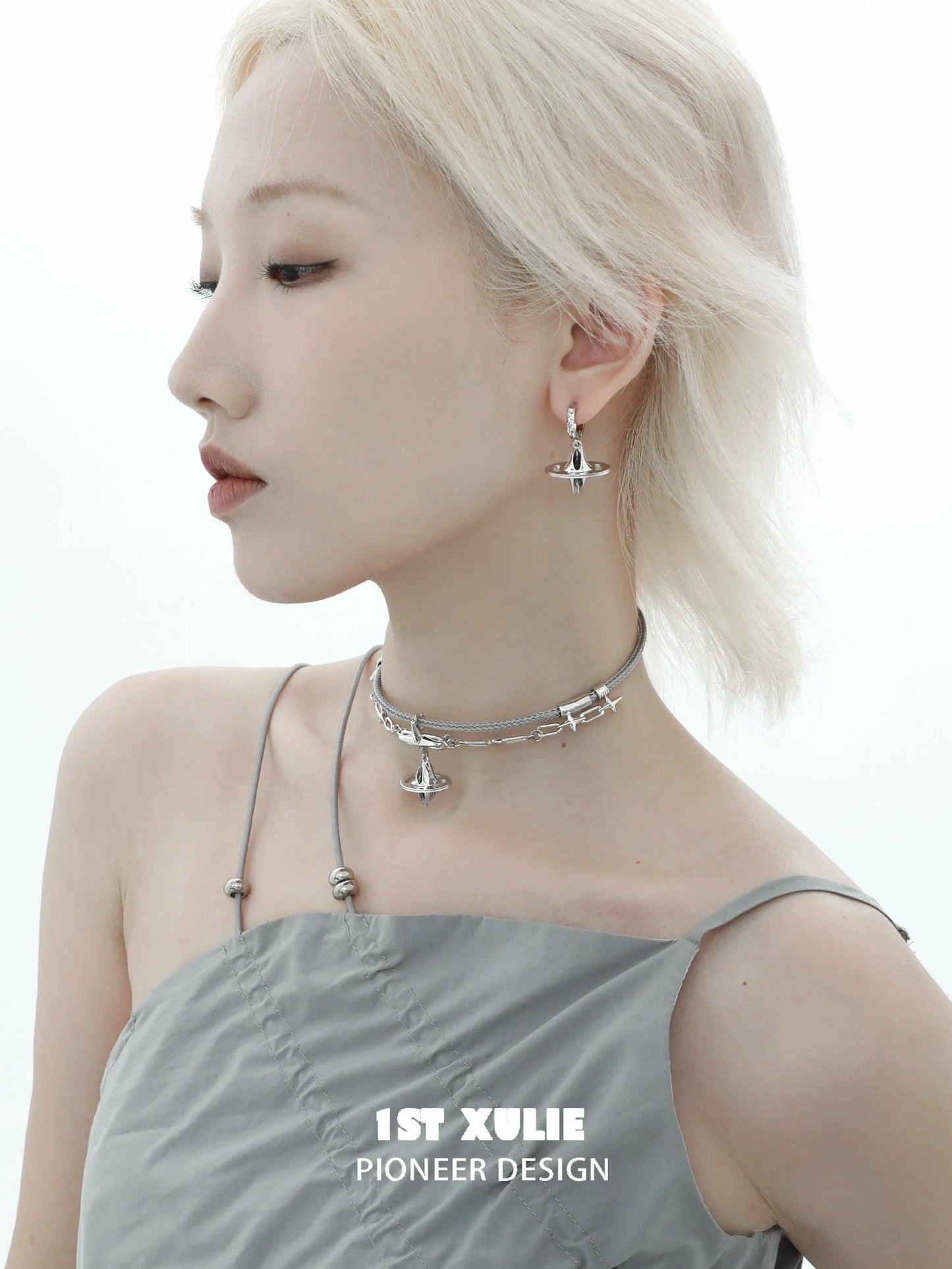 Model wearing 1STXULIE futuristic dream core earrings with a sleek silver choker for a modern look