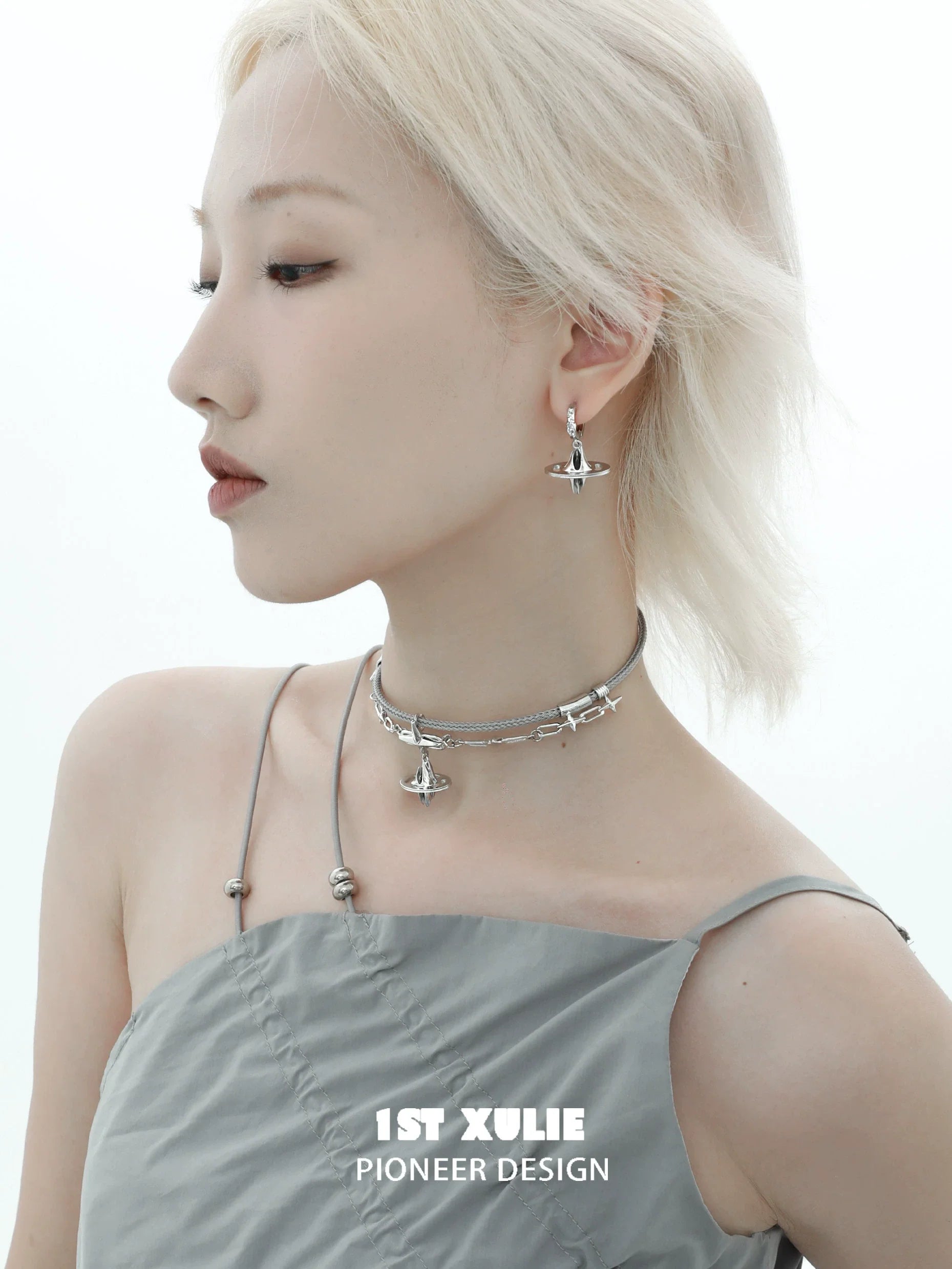 Model wearing 1STXULIE futuristic dream core earrings with a sleek silver choker for a modern look