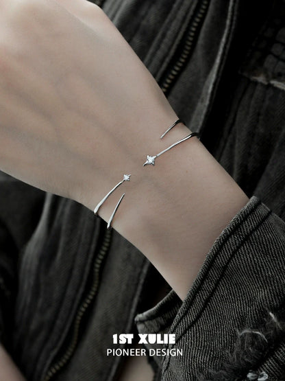 Futuristic silver bracelet featuring a sleek design with star embellishments for modern style