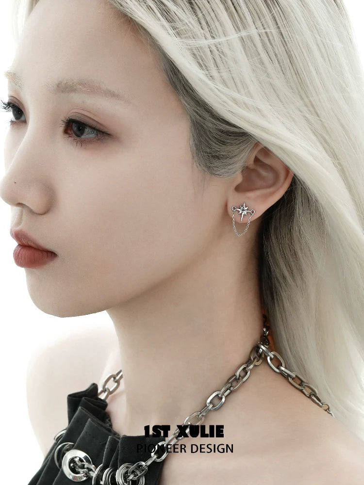 Futuristic star chain earrings in silver on model showcasing a modern aesthetic style