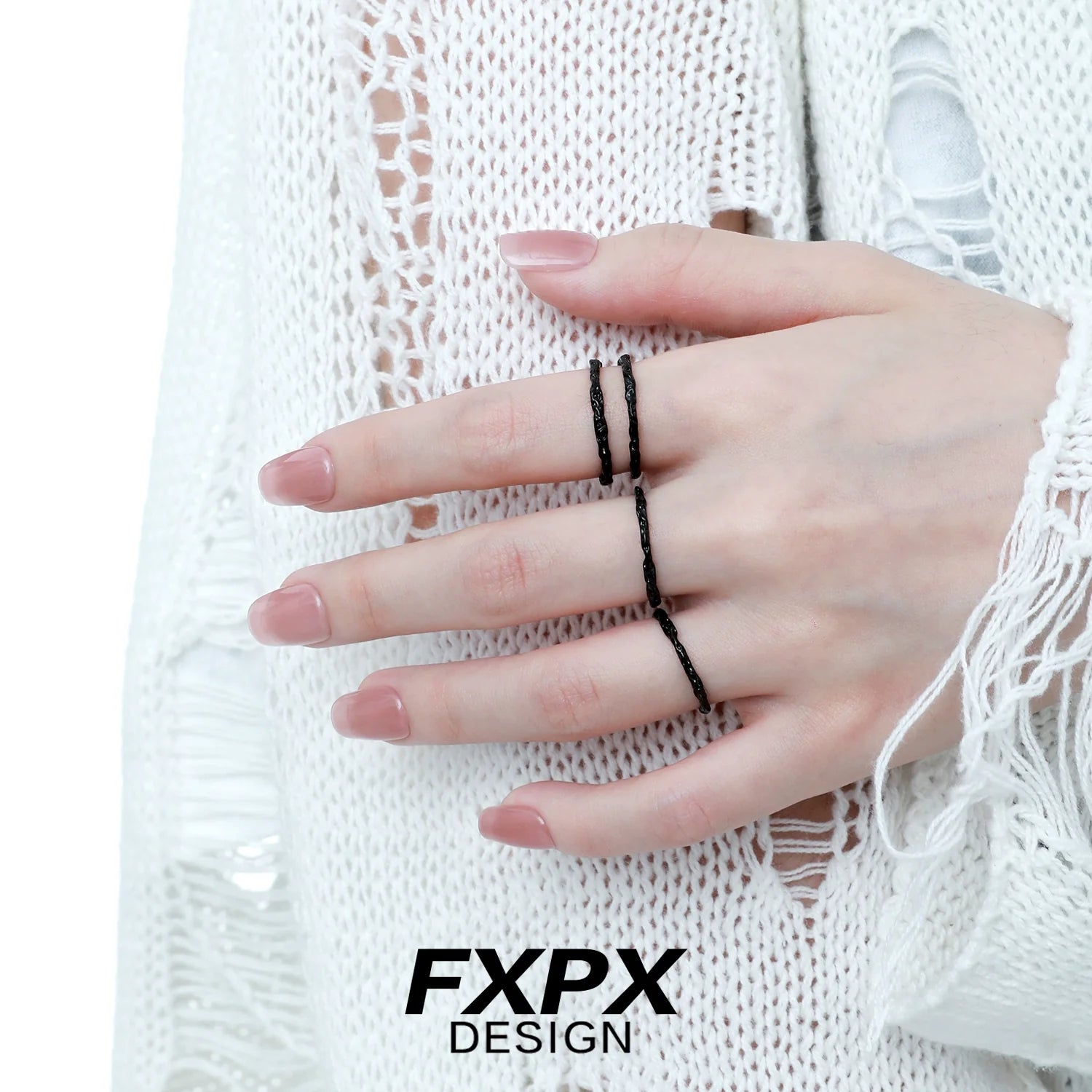 FXPX black tinfoil texture ring displayed on a model's hand with a stylish outfit