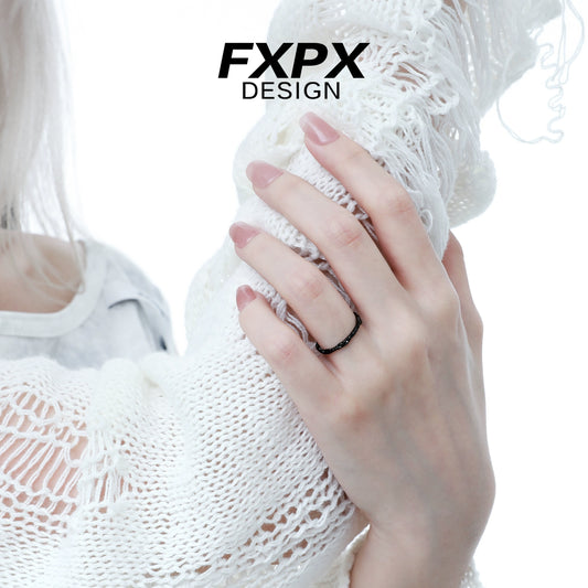 FXPX black tinfoil texture ring displayed on a hand with a white sweater for a stylish look
