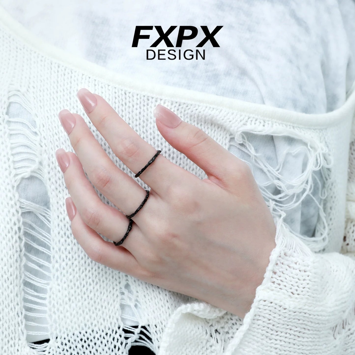 Stylish black tinfoil texture ring worn on fingers, showcasing a modern design by FXPX