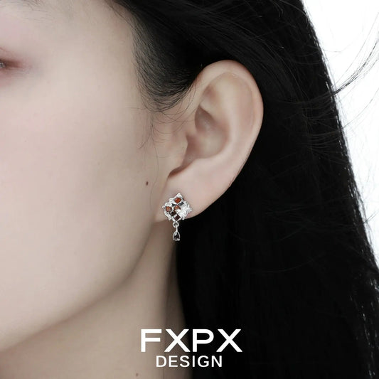 Bloody doll jewelry gothic checkerboard earrings worn on ear with silver and red detailing