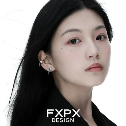 Woman wearing bloody doll jewelry gothic checkerboard earrings with silver and black design