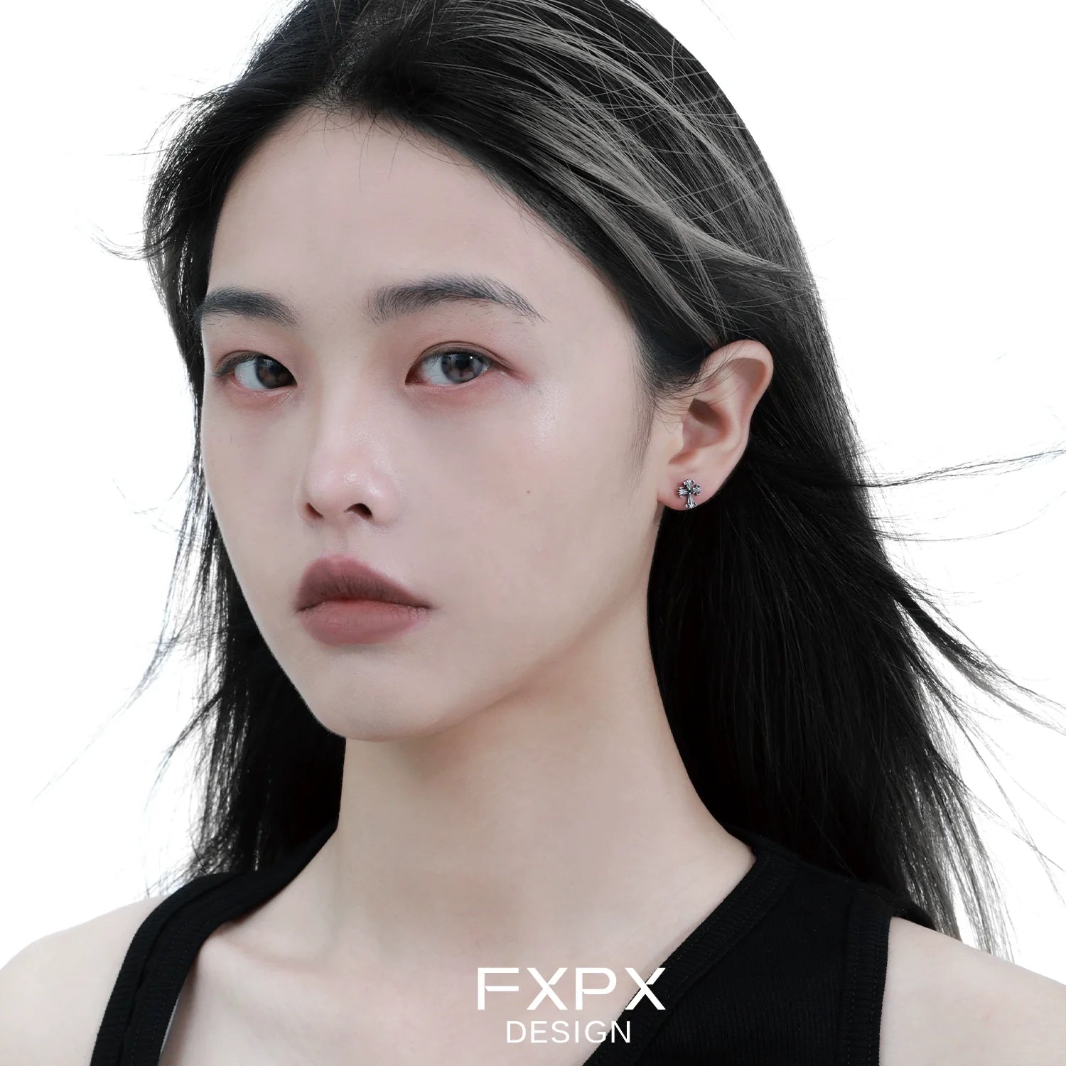 Model wearing bloody doll jewelry gothic cross stud earrings from FXPX with black hair and neutral makeup