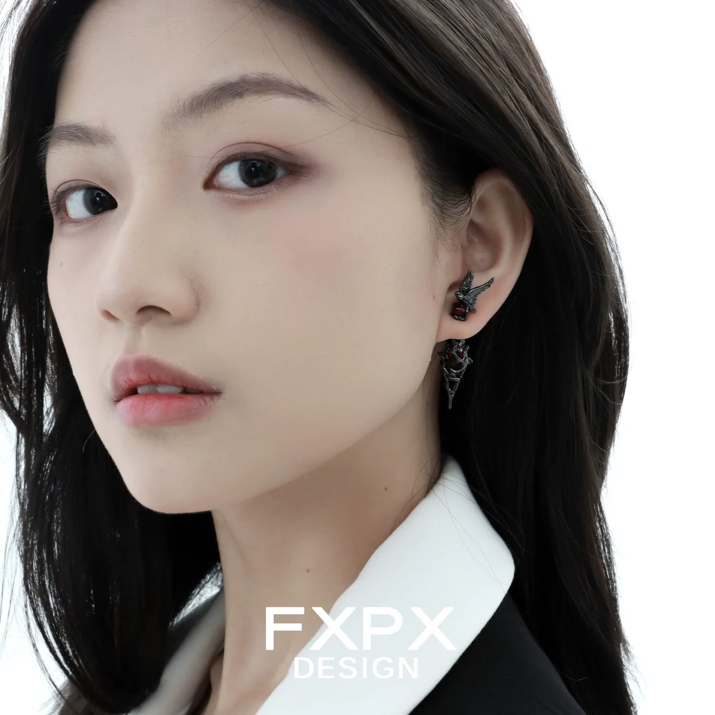 Bloody Doll Jewelry gothic raven earrings worn by a woman with black hair and white collar