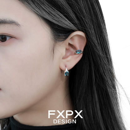Bloody Doll Jewelry mystic iceland ear cuffs worn on a woman's ear with matching blue gemstone earrings