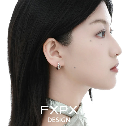 Elegant blue and white serpentine zircon earrings showcased on a model's ear