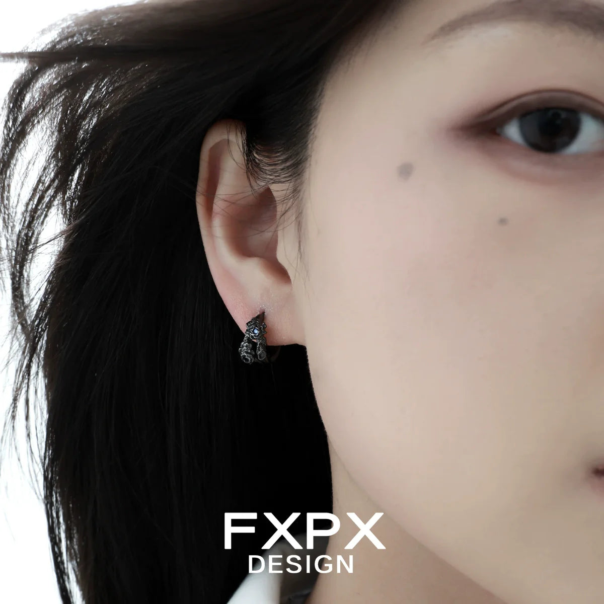FXPX blue black rose stud earrings worn by a model showcasing elegant design and detail