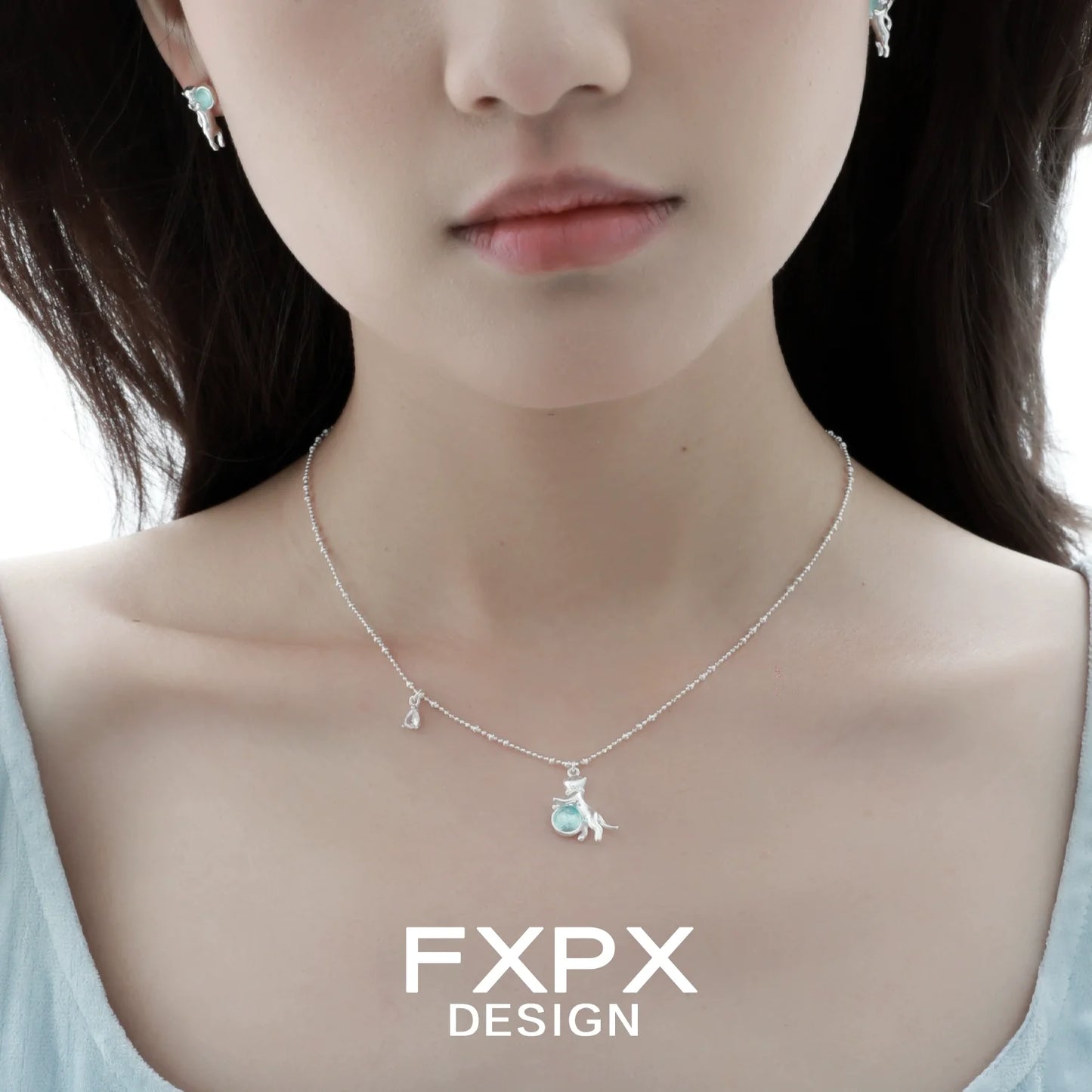 Beautiful blue cat pendant necklace by FXPX with matching earrings for a stylish look