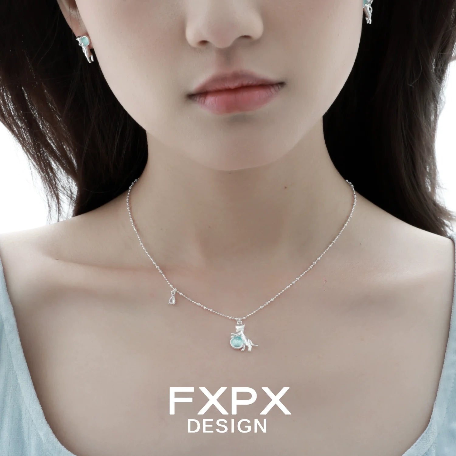 Beautiful blue cat pendant necklace by FXPX with matching earrings for a stylish look
