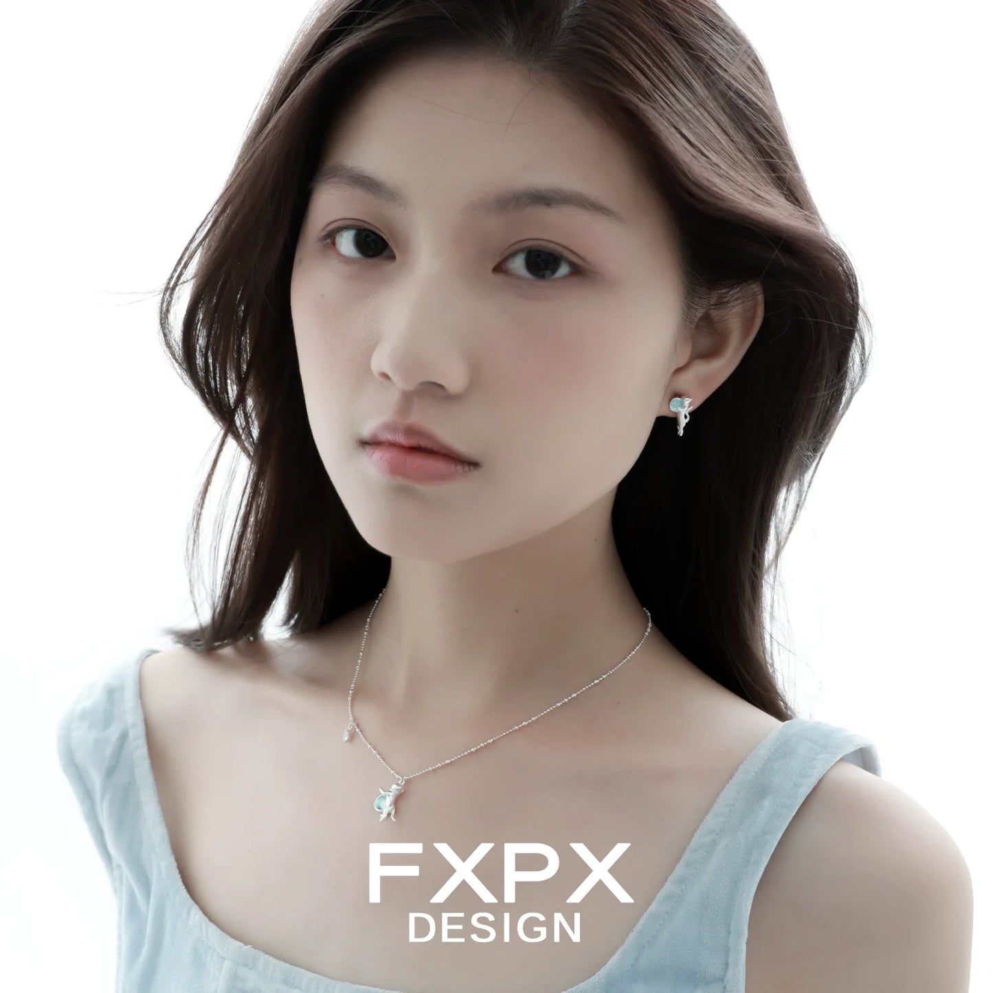FXPX blue cat pendant necklace displayed on a model with matching earrings