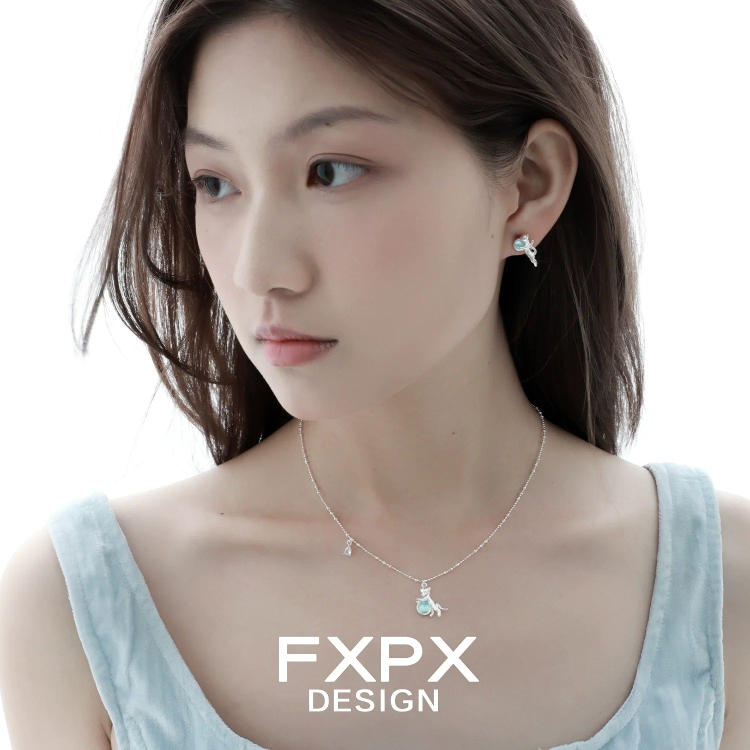 Elegant blue cat pendant necklace from FXPX, paired with matching earrings for a stylish look