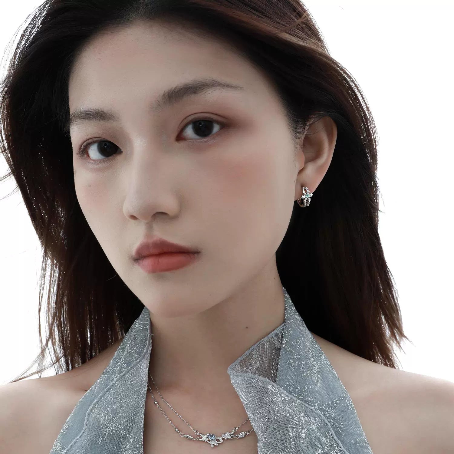 Elegant model wearing a blue crystal necklace paired with matching earrings for a stylish look