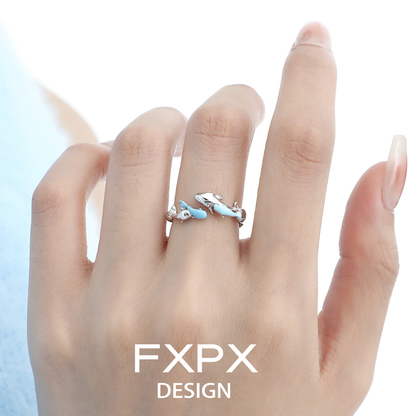 FXPX Blue Fish Wave Ring featuring intricate design on a finger in natural light