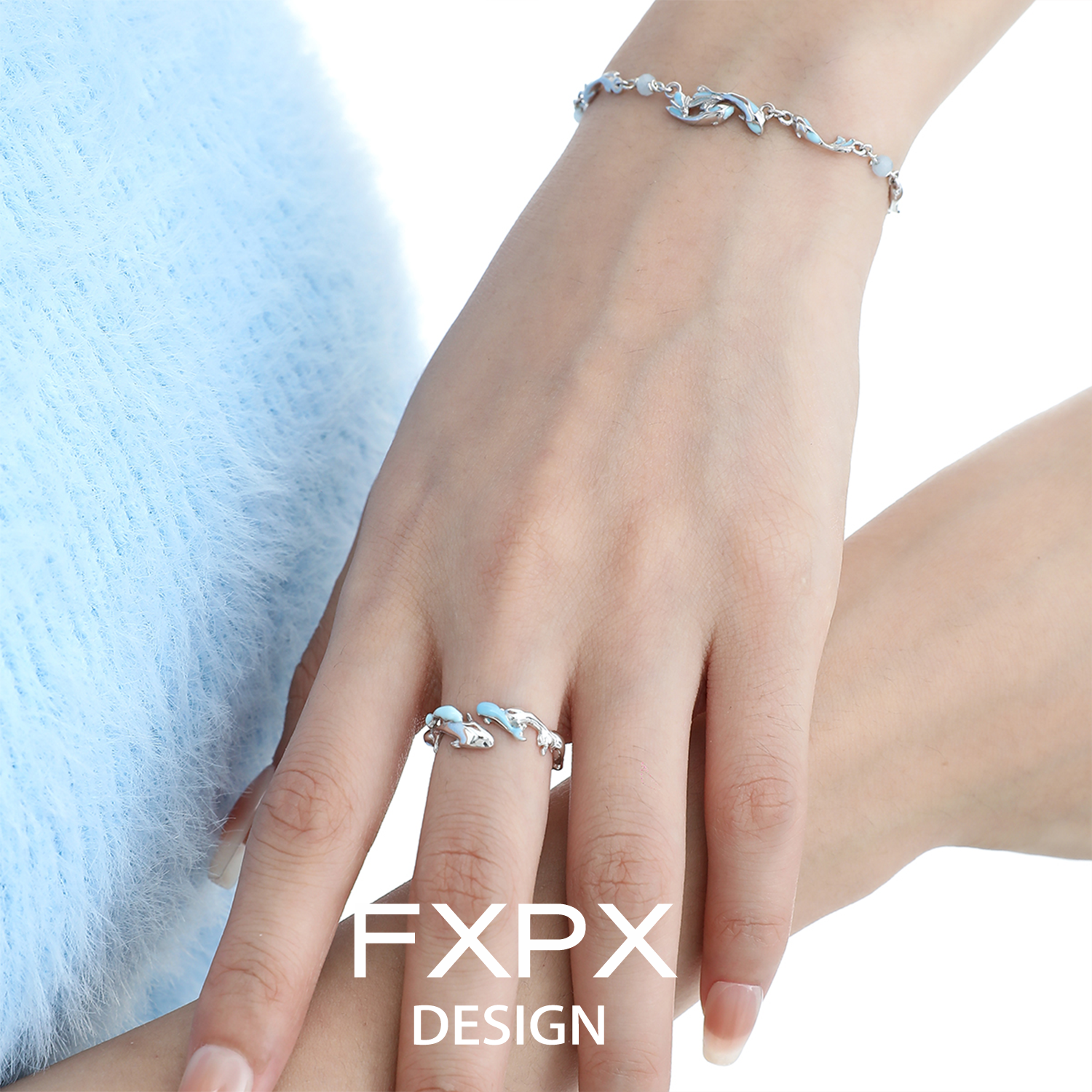 FXPX blue fish wave ring elegantly worn on a hand, showcasing its unique design and shimmering detail