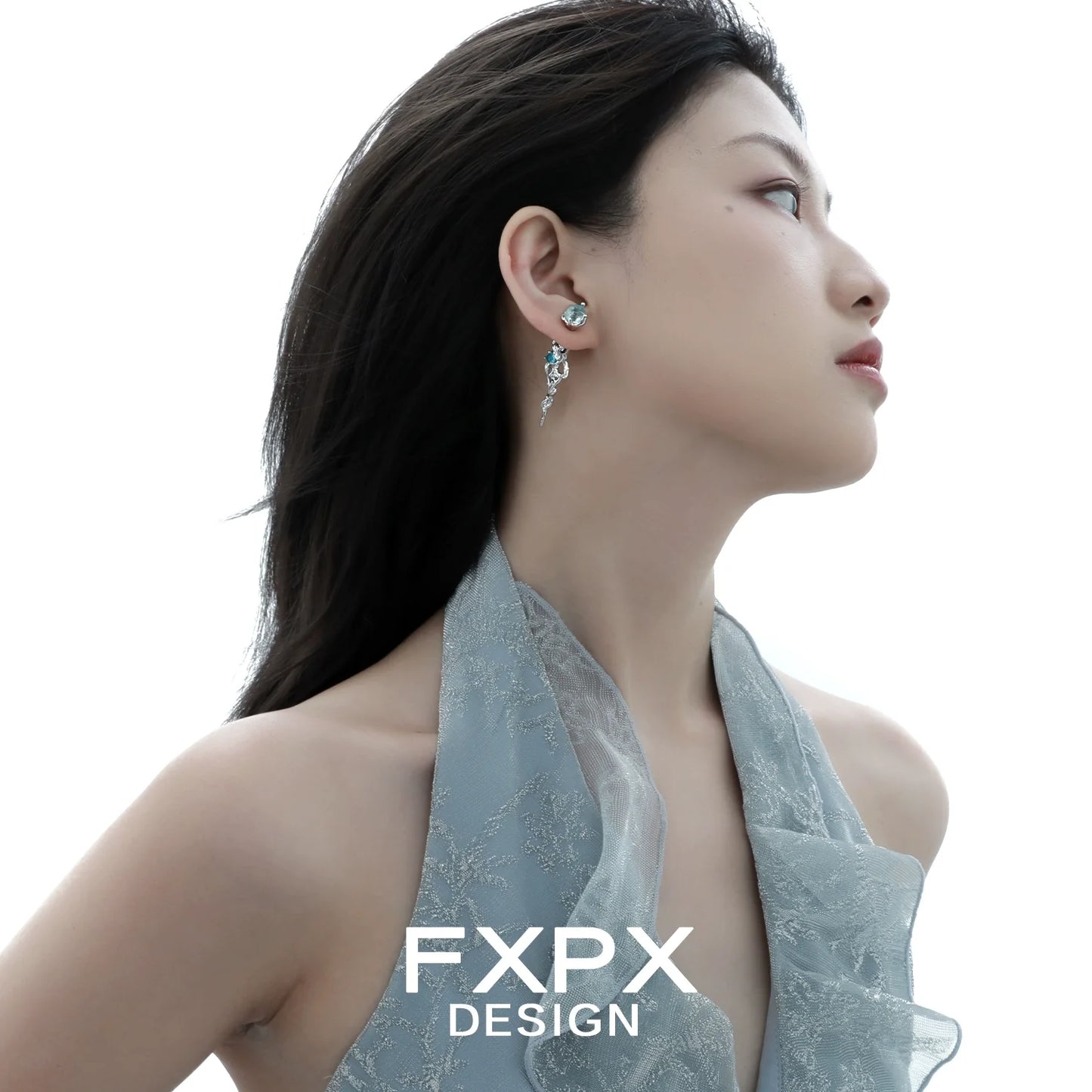 Elegant blue glacier earrings designed by FXPX, featuring unique icy motifs on a model