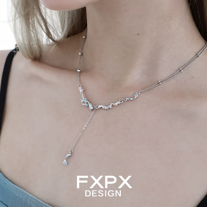 Elegant blue mermaid necklace featuring delicate charms and a stylish chain design