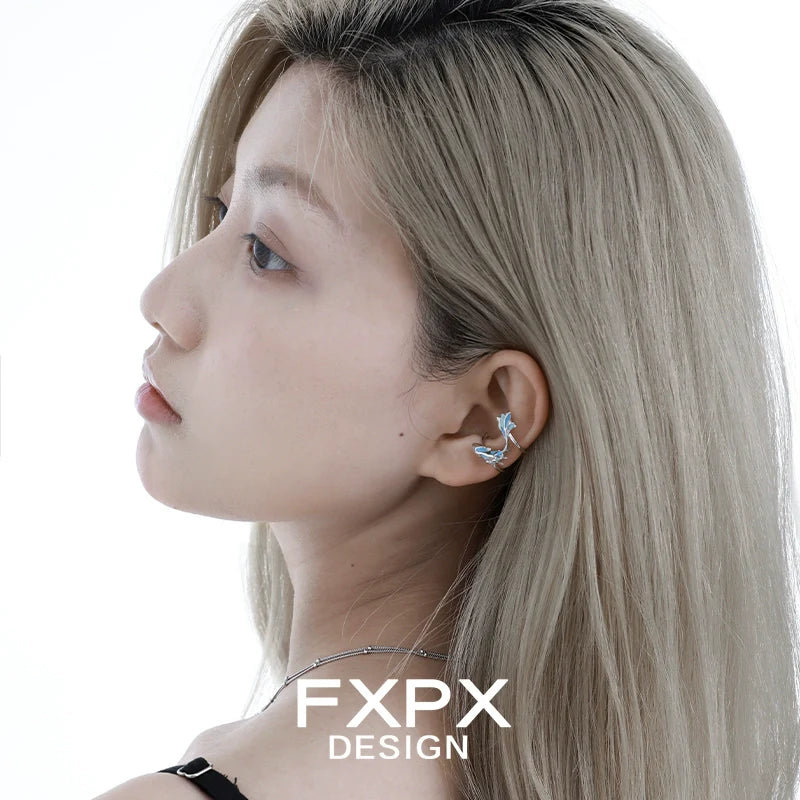 Elegant blue sea ear cuff by FXPX, showcasing a unique design on a model's ear