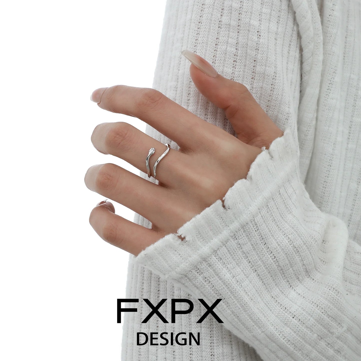 FXPX blue white snake ring elegantly displayed on a model's hand with soft sweater background