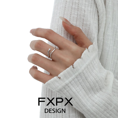 FXPX blue white snake ring elegantly displayed on a model's hand with soft sweater background