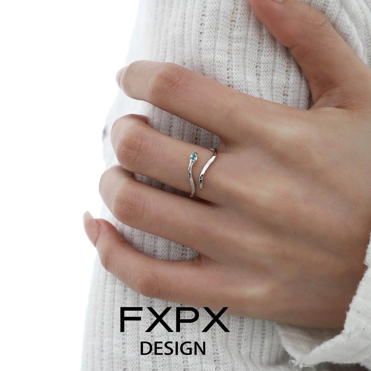 Stylish FXPX blue white snake ring on a hand with trendy design and gemstone accent
