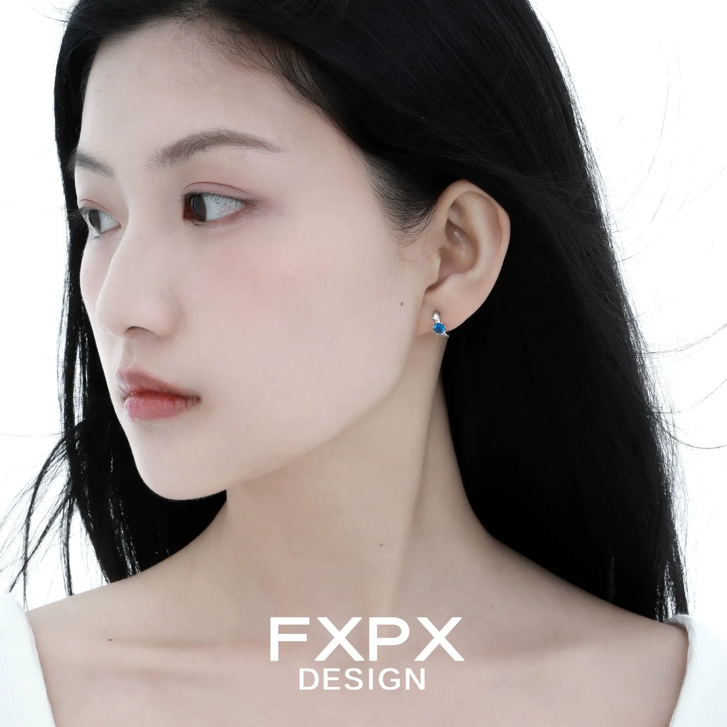 Elegant blue zircon earrings showcased on a model with long dark hair and a soft expression